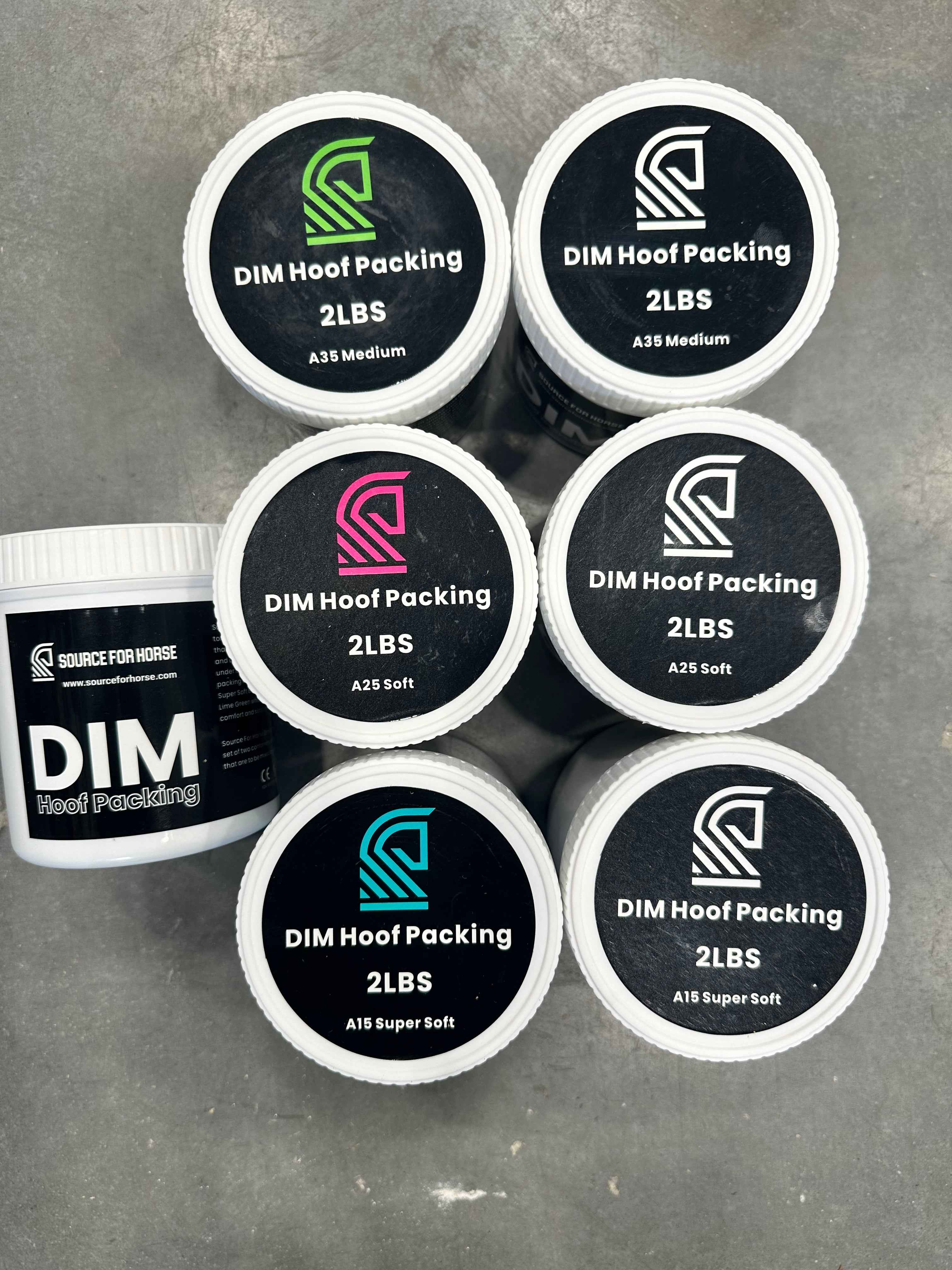 Six white plastic tubs of DIM Hoof Packing by Source for Horse